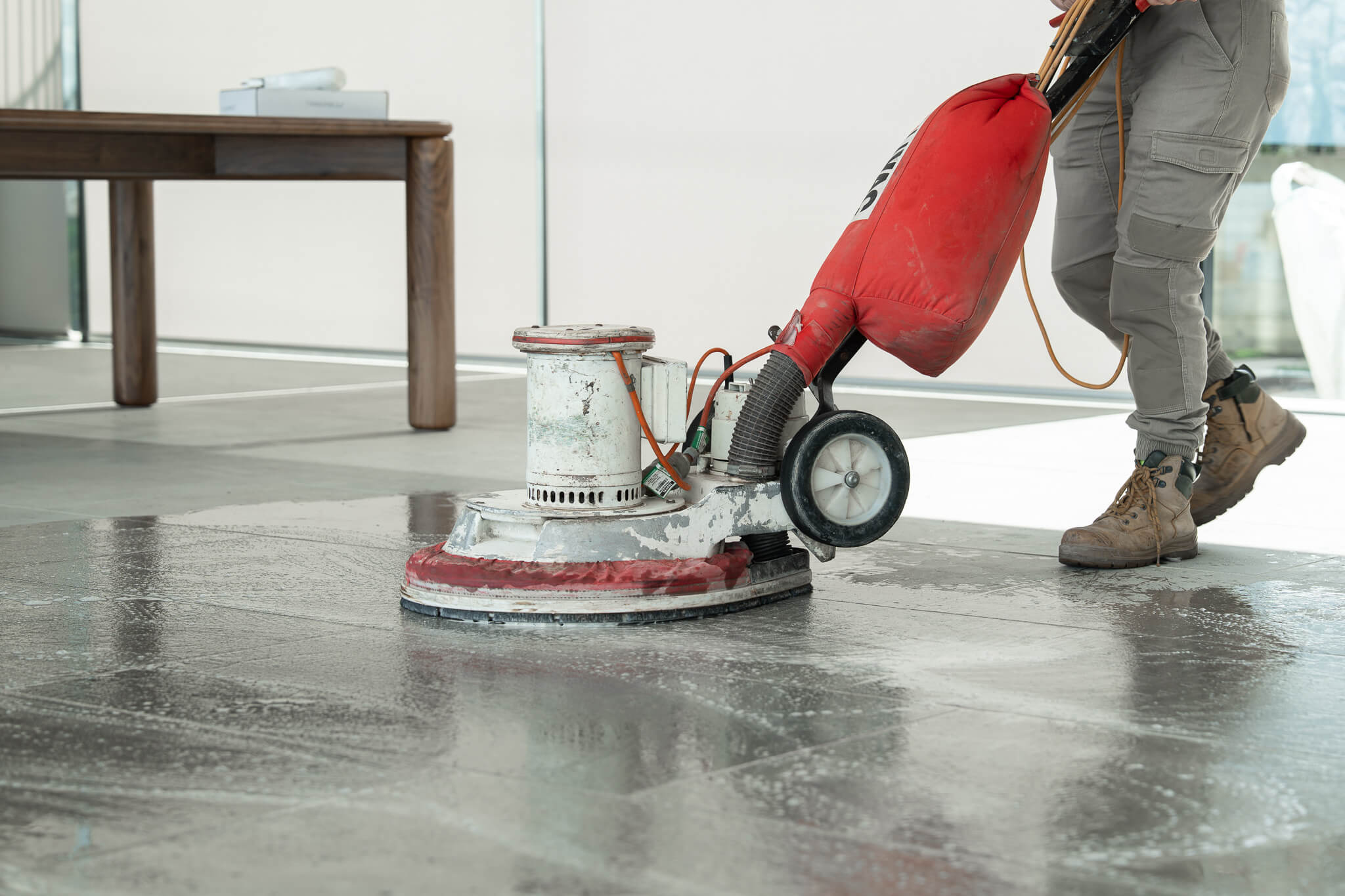 A cleaner clearing dust and debris after a renovation